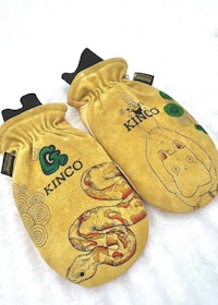 a pair of yellow mittens with a cat on them