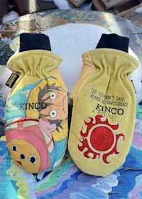 a pair of yellow mittens with a cartoon character on them