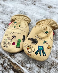 a pair of mittens with minecraft drawings on them